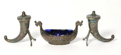 Lot 256 - A pair of Norwegian silver horn shaped salt and pepper pots, together with a Viking boat shaped...