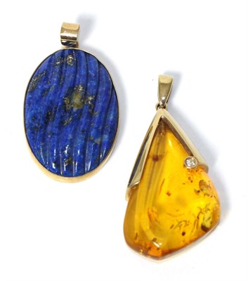 Lot 258 - A 9 carat gold amber and diamond pendant, measures 4cm by 2cm, and a 9 carat gold lapis lazuli...