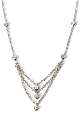 Lot 260 - An 18 carat white gold diamond necklace, the front with three trace chain strands each suspending a