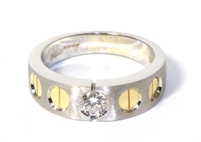 Lot 261 - An 18 carat two colour gold solitaire diamond ring, a round brilliant cut diamond inset to a...