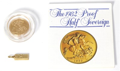 Lot 275 - A 1982 half sovereign together with a small ingot pendant stamped 14K