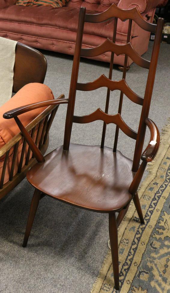 Lot 1152 - An Ercol dark elm sofa and an Ercol chair (2)