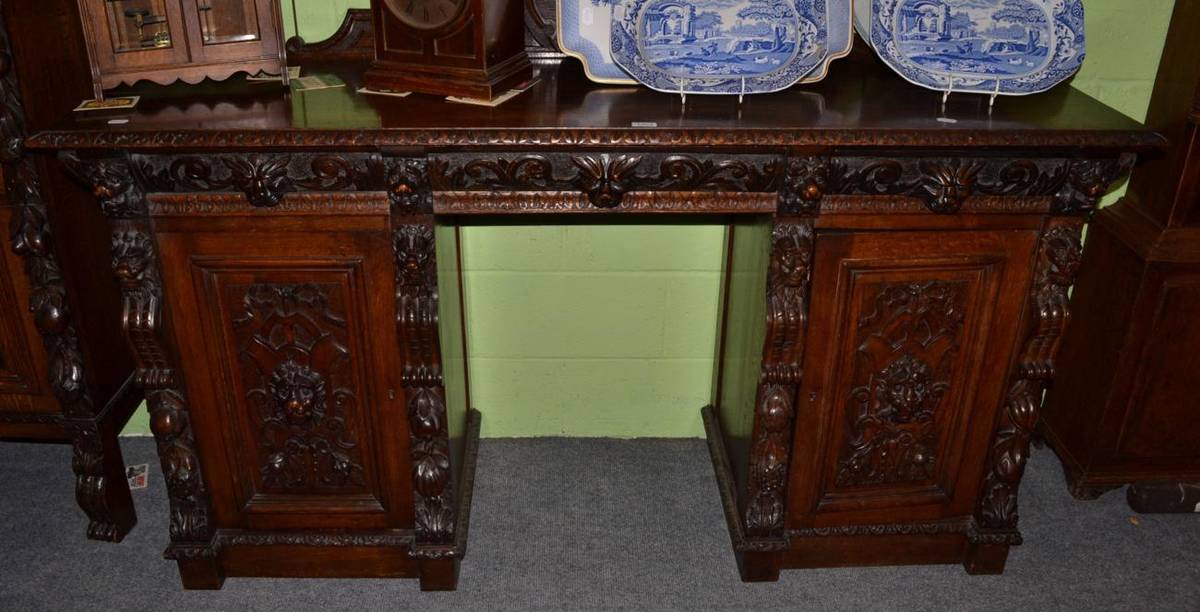 Lot 1403 - A late 19th century carved oak sideboard