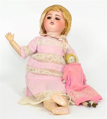 Lot 19 - SFBJ 60 bisque socket head doll in a pink dress and straw bonnet and a bisque dolls house doll (2)