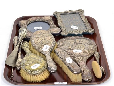 Lot 20 - A collection of silver mounted brushes, picture frames, nail buff etc., mostly decorated with...