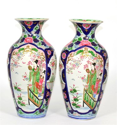 Lot 24 - A pair of Chinese famille rose baluster vases
