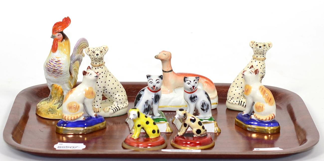 Lot 52 - A group of reproduction Staffordshire and other models including two pairs of seated cats,...