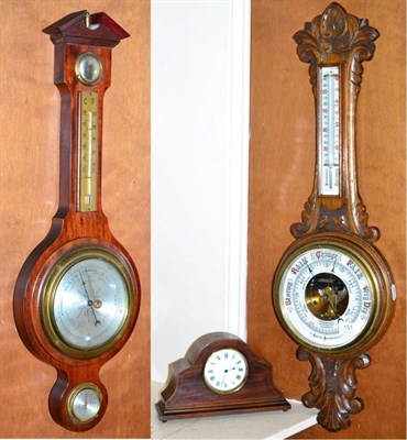 Lot 151 - A carved oak cased aneroid barometer, another barometer and an inlaid mantel timepiece (3)