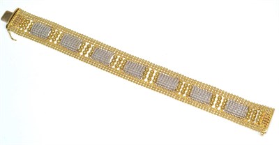 Lot 163 - A fancy link two colour bracelet, formed of seven panels of white beads, to yellow bead frames,...