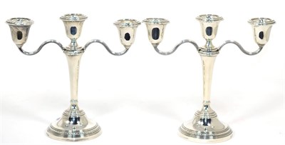 Lot 189 - A pair of silver three light candleabra, Elkington & Co, Birmingham 1967, with laurel borders,...