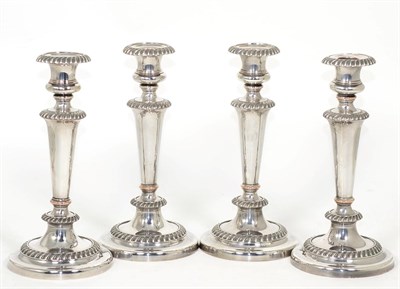 Lot 207 - A set of four Old Sheffield plate candlesticks, early 19th century, with gadroon borders and...