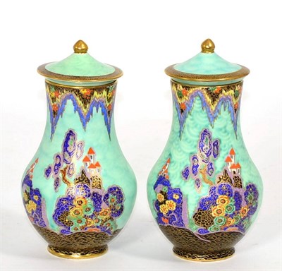 Lot 236 - A pair of Crown Devon vases and covers, decorated with fairy castle pattern