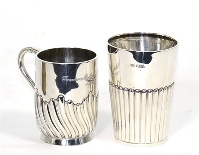 Lot 239 - A silver beaker, Atkin Bros, Sheffield 1900, with fluted lower body; and a silver mug, Jackson...