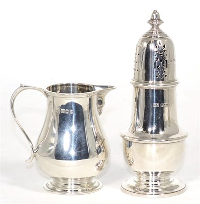 Lot 244 - A silver baluster cream jug, Edward Barnard & Sons, London 1919; and a silver pedestal caster,...