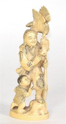 Lot 247 - An ivory okimono, hunter with boy, early 20th century