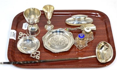 Lot 282 - A tray of assorted small silver items including a tea strainer, a double measure, a Kiddush...