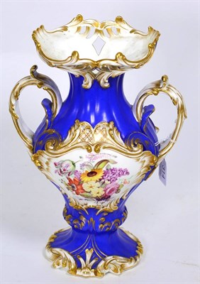 Lot 314 - A 19th century English blue ground twin handled vase, painted with a floral reserve