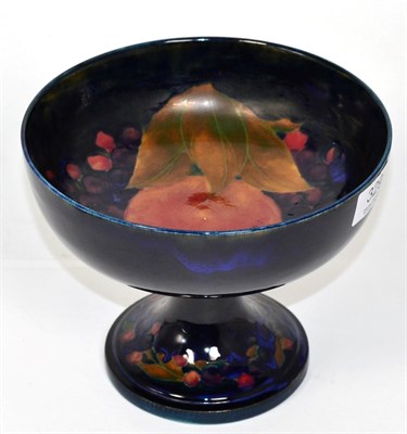 Lot 329 - William Moorcroft Pomegranate pedestal bowl on a blue ground