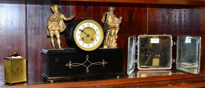 Lot 371 - An ebonised mantel clock surmounted with gilt metal figures; a small three section travelling...