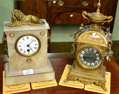 Lot 377 - A white onyx mantel clock with lion surmount and a gilt metal mantel clock (2)