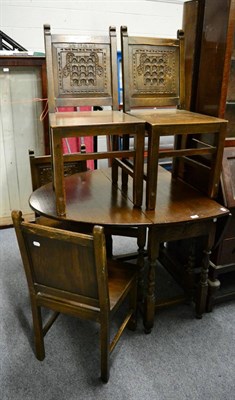 Lot 1040 - An oak gate leg table and four chairs