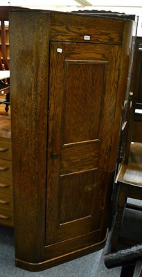 Lot 1041 - An oak freestanding corner hall cupboard