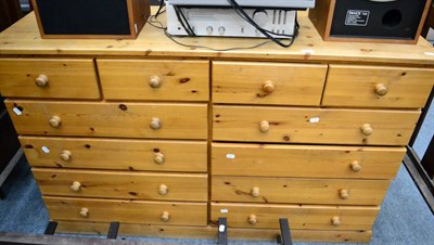 Lot 1044 - A modern pine chest of drawers fitted with an arrangement of twelve drawers