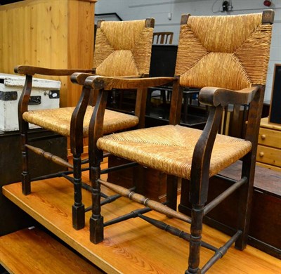 Lot 1053 - A pair of Arts & Crafts oak and rope work elbow chairs together with a mid 20th century leather...