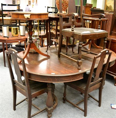 Lot 1063 - An oval oak extending dining table and six chairs