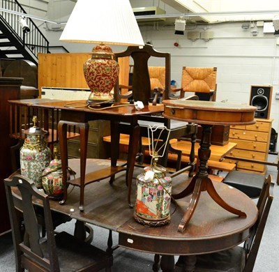 Lot 1064 - A reproduction revolving bookcase, similar drum table, a Pembroke table and various table lamps (7)