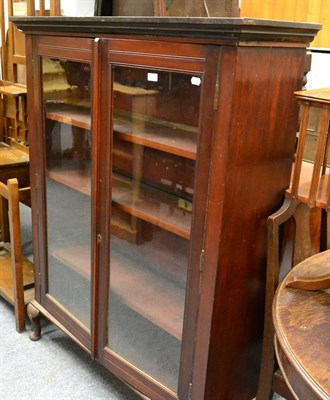 Lot 1065 - A glazed mahogany bookcase on cabriole supports