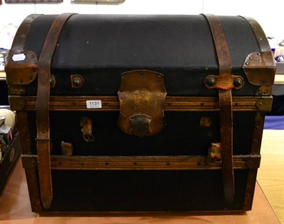 Lot 1131 - A leather bound dome top trunk