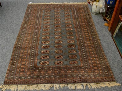 Lot 1134 - Lahore Bukhara rug, Pakistan, the dove grey field with three rows of quarted guls, enclosed by...