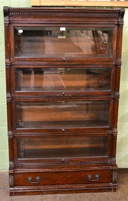 Lot 1198 - An oak Globe Wernicke four section glazed bookcase with single drawer base