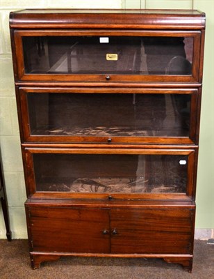 Lot 1200 - A Wilton of Newcastle three height sectional glazed bookcase on cupboard base