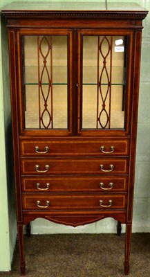 Lot 1201 - An Edwardian mahogany and crossbanded glazed music cabinet, four drawers, square tapered legs,...