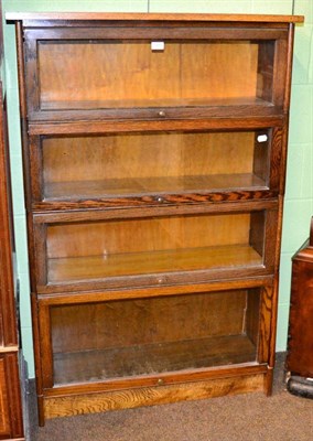 Lot 1205 - A glazed oak four height sectional bookcase