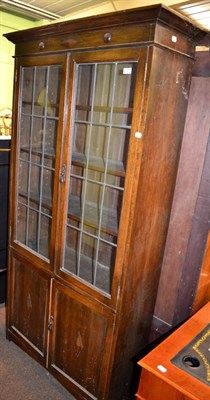 Lot 1210 - A glazed oak bookcase