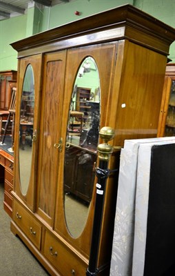 Lot 1215 - An Edwardian line inlaid mahogany wardrobe, with a pair of mirrored doors