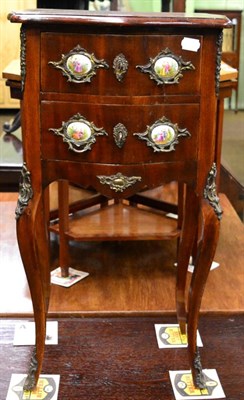 Lot 1217 - A French mahogany two drawer bedside table, 20th century with gilt mount and porcelain plaques,...