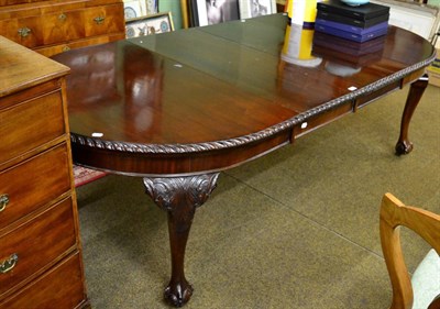 Lot 1250 - An early 20th century mahogany dining table, in the Chippendale style, raised on cabriole legs...