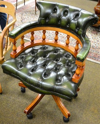 Lot 1251 - A green buttoned leather swivel desk chair