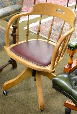 Lot 1252 - A spindle back swivel desk armchair