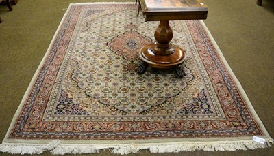 Lot 1267 - An Indian carpet, the cream Herati field with central medallion framed by samovar motif...