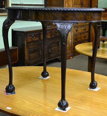 Lot 1279 - An oval occasional table on foliate cabriole supports, on lion paw feet