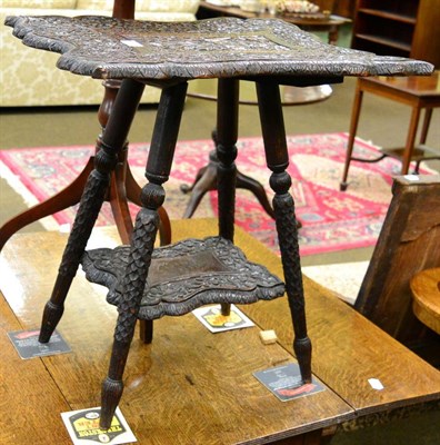 Lot 1283 - An Indian carved wood occasional table