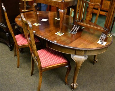 Lot 1300 - Early 20th century mahogany oval extending dining table with one spare leaf and winder; and a...