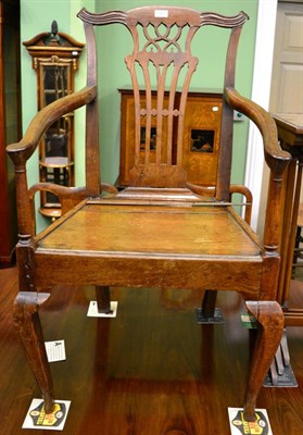 Lot 1301 - A provincial oak armchair with solid seat and pierced splat