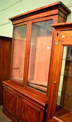 Lot 1308 - A Victorian mahogany bookcase with a pair of glazed doors above a pair of cupboard doors