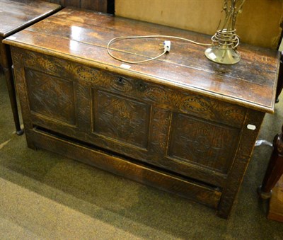 Lot 1320 - An oak blanket chest with carved, panelled frieze